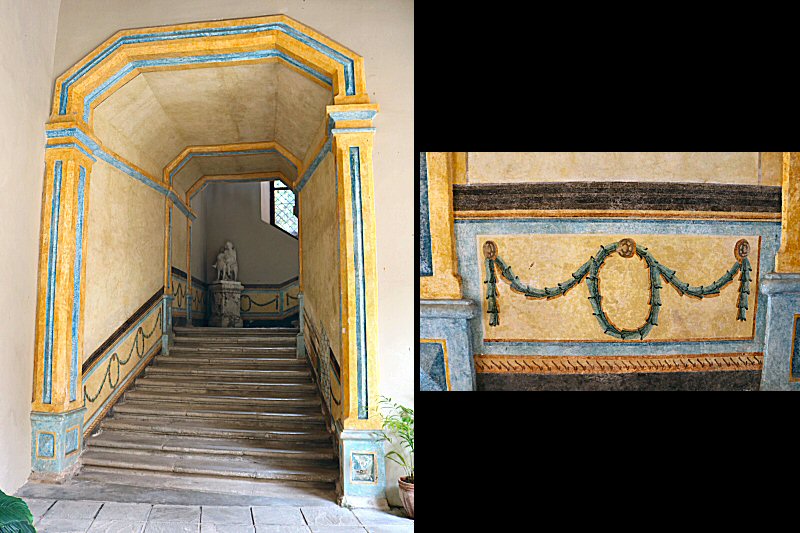 Italian-style staircase with mural paintings that leads to the upper floor