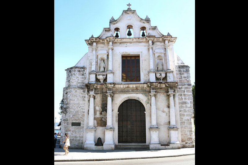 A belfry with three bells is placed on the façade, crowned by a cross.