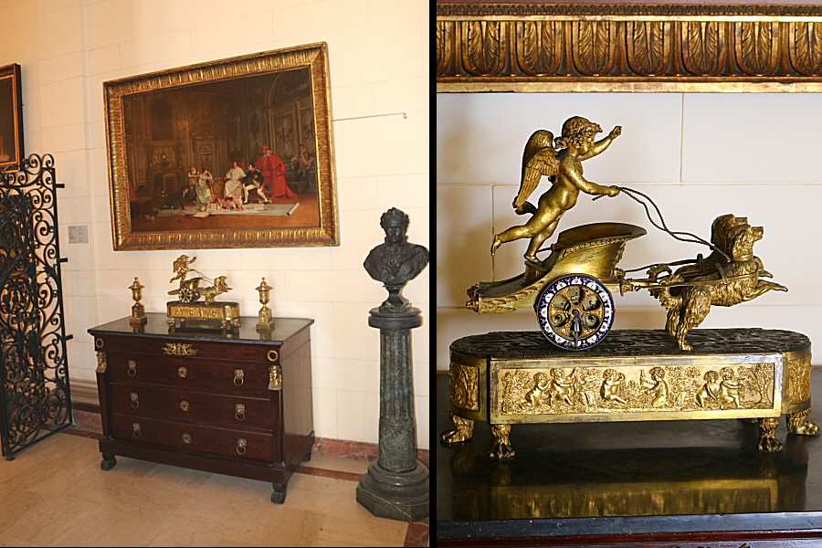 a pair of gilded bronze candlesticks, placed on a console with drawers, made of mahogany. These candlesticks were used by Joseph Bonaparte.