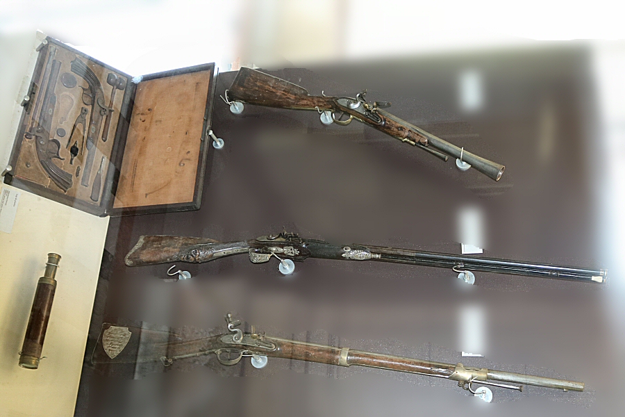 1814 double barrel shotgun manufactured by Deboubert of Paris (in the middle) and the telescope used by Napoleon while he was a prisoner in Longwood House on St. Helena island.